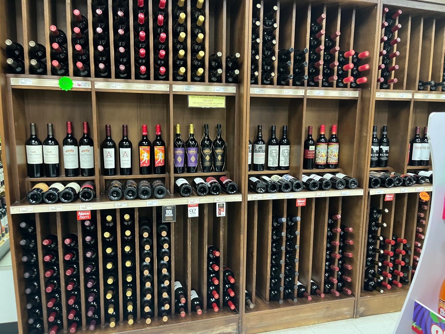 Wine bottles arranged on wooden racks